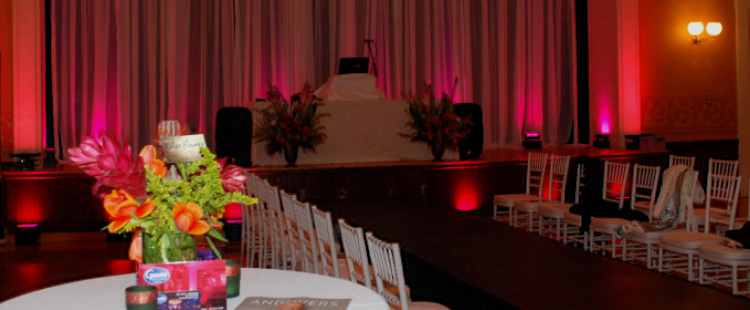 Fashion show runway and dining tables before a fundraiser